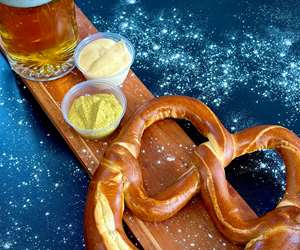 pretzel with mustart and a beer